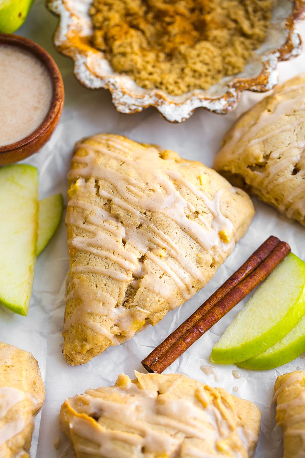 Close up of a apple cinnamon scone recipe with a glaze on top. 