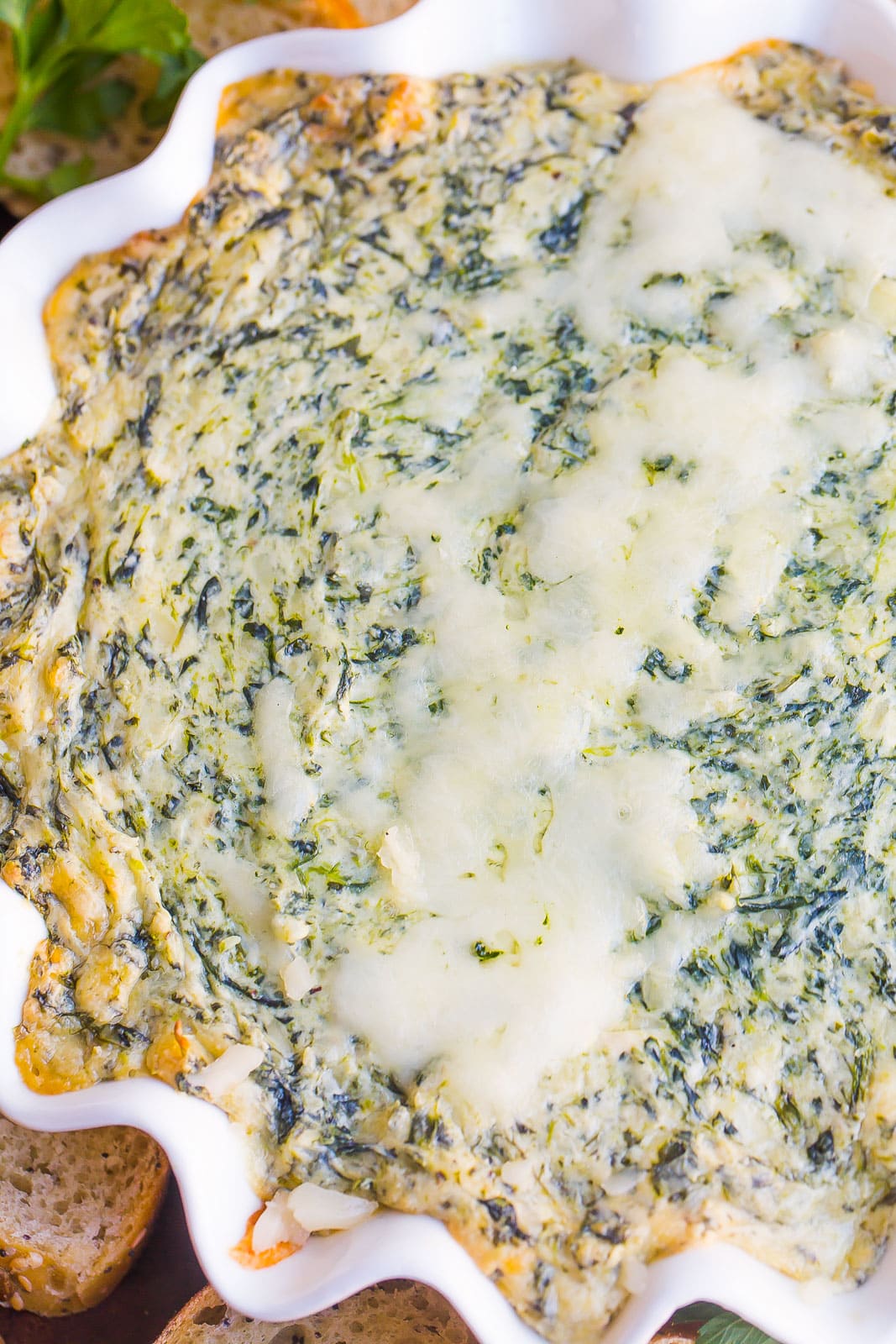 Spinach dip with cheese on top.