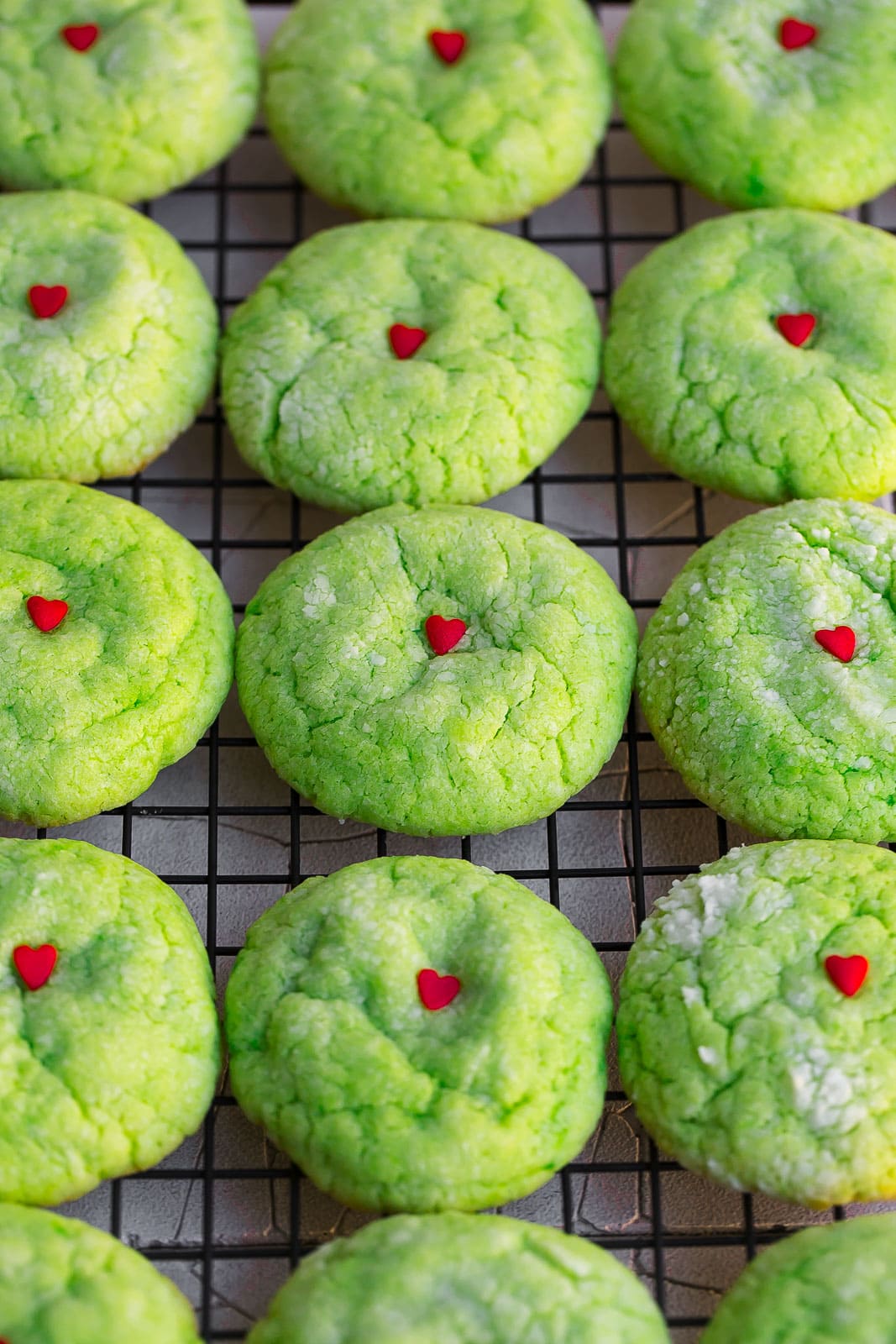 Grinch cookies on a cooling rack.
