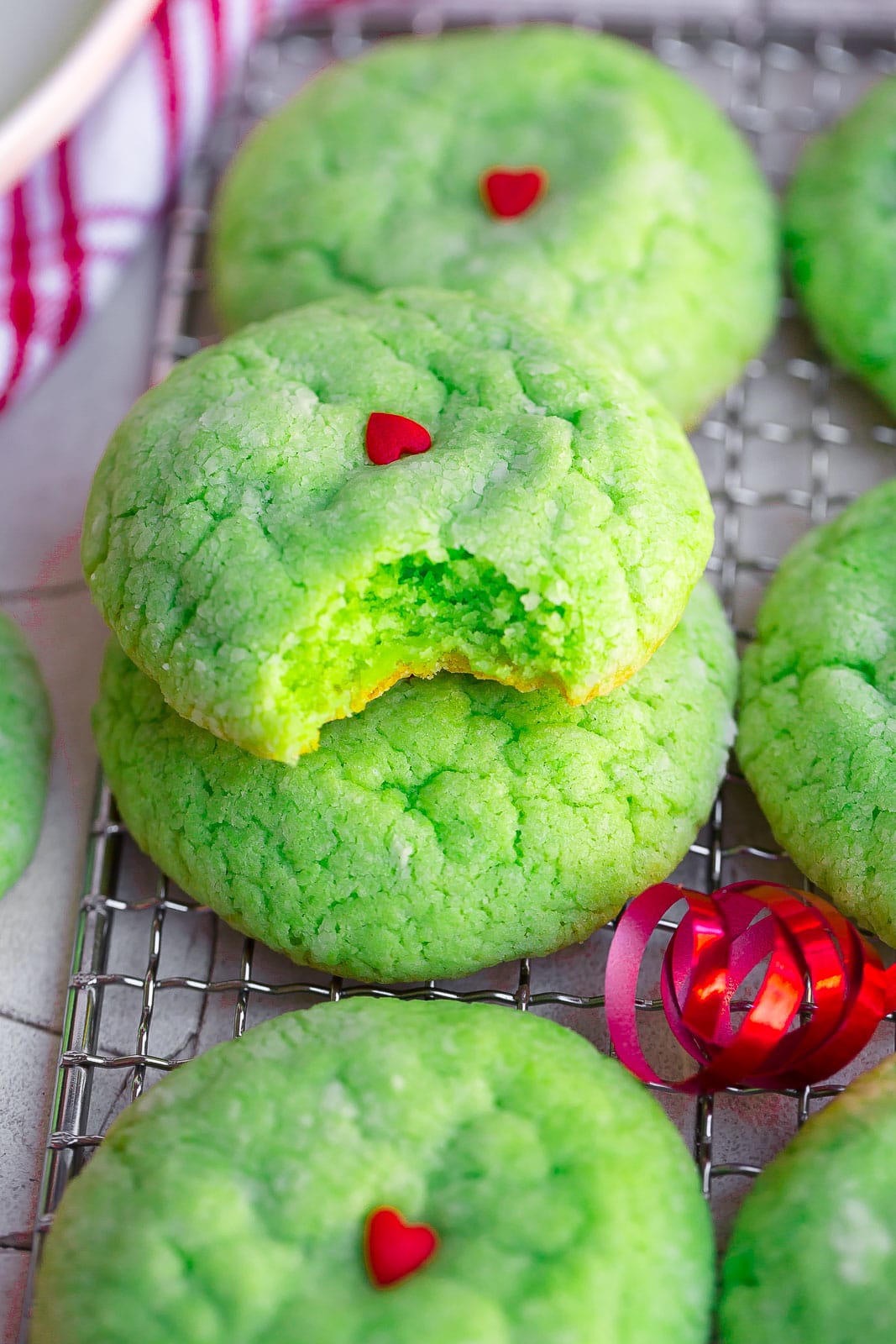 Close up view of homemade Grinch cookie with bite mark.