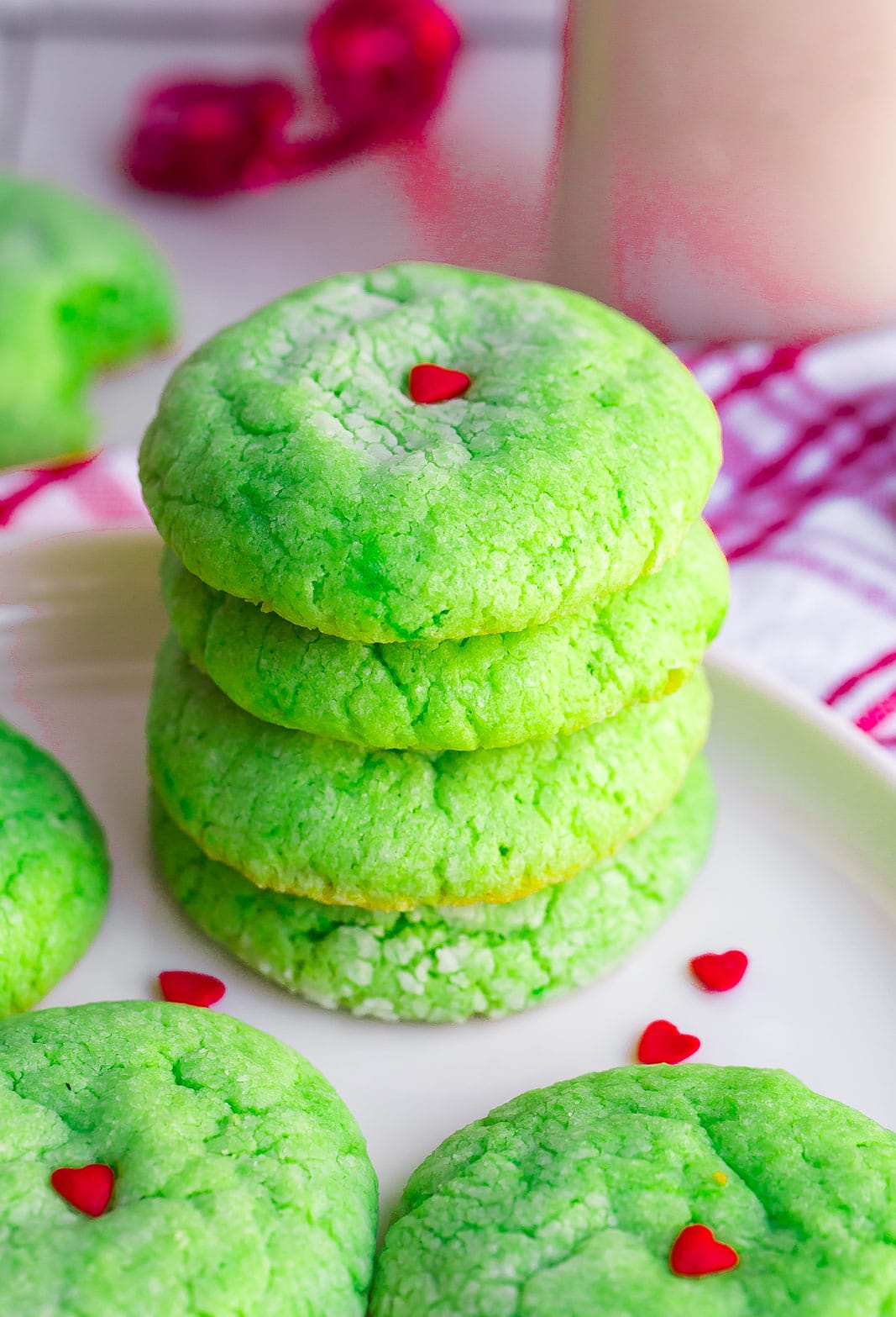 Stack of Grinch Cake Mix Cookies on a white plate.