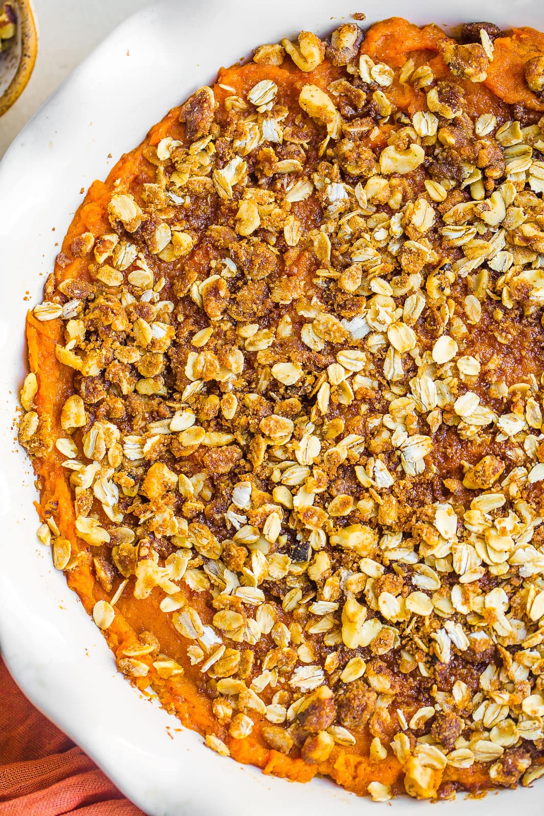 Close up view of sweet potato casserole recipe with pecan oat crumble topping.