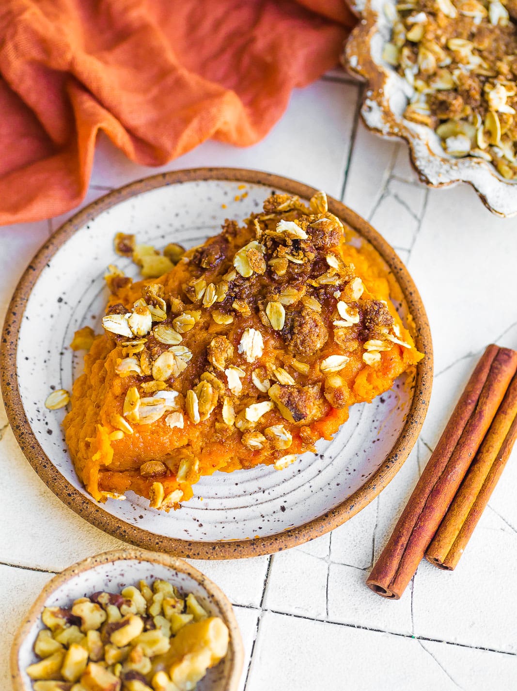 Healthy Sweet Potato Casserole in a speckled ceramic dish. 