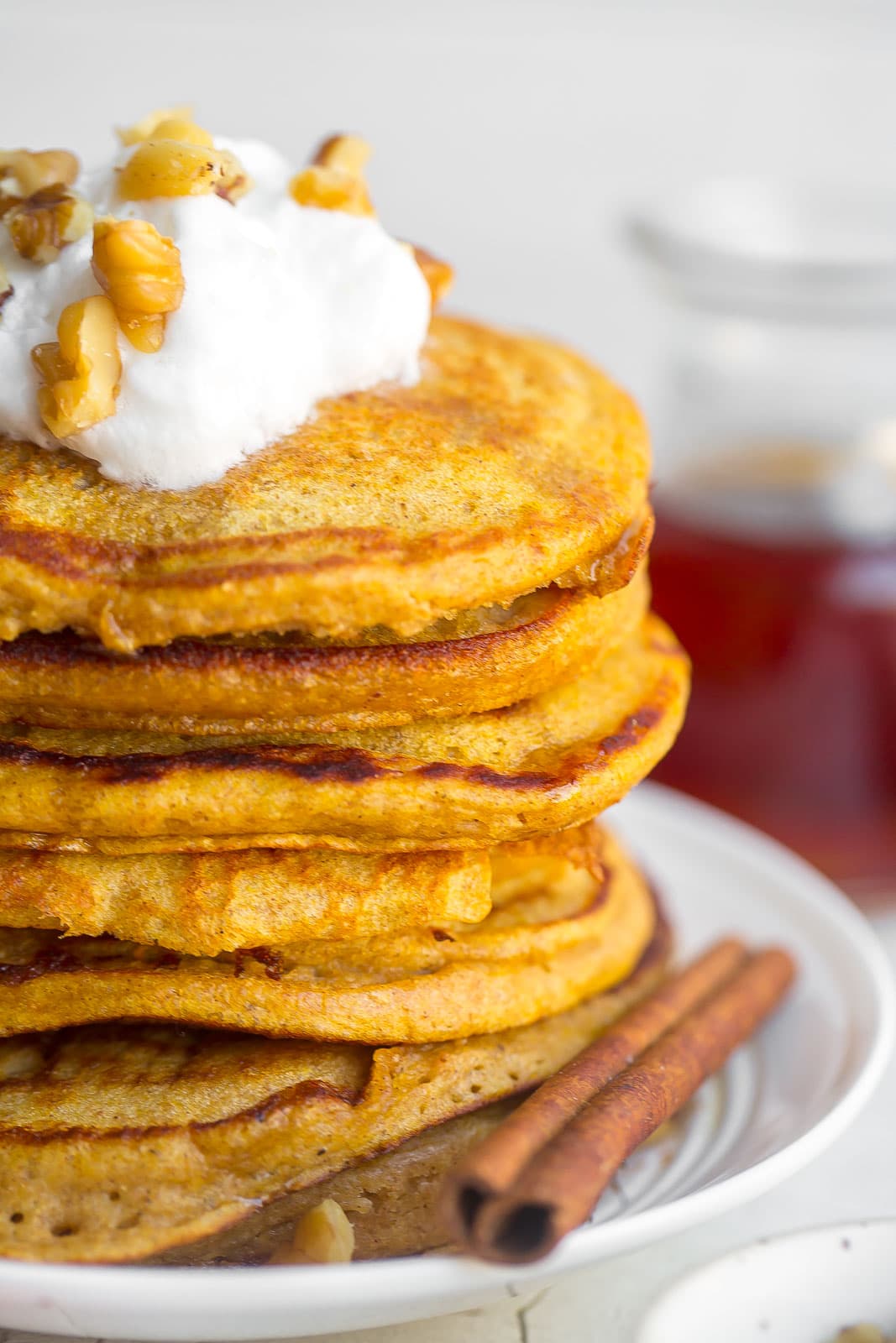 Side view of a stack of pumpkin spice pancakes.
