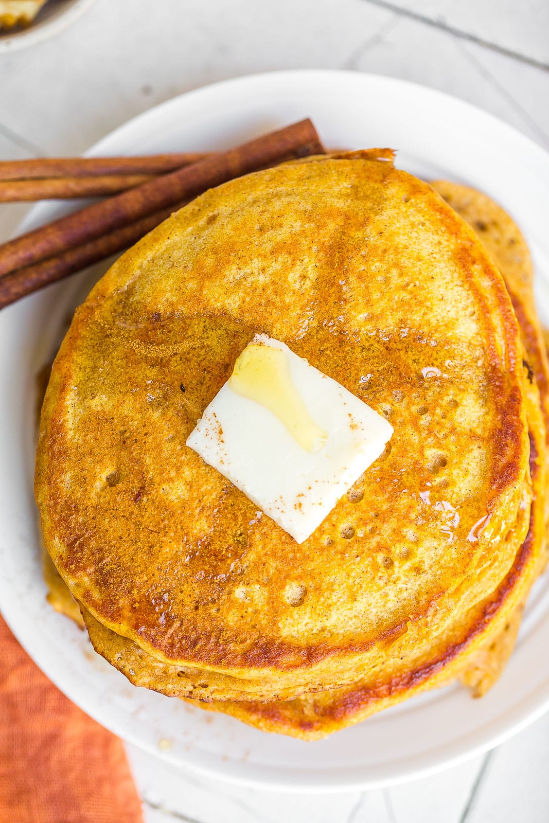 The best Pumpkin Spice Pancake Recipe on a white plate. 