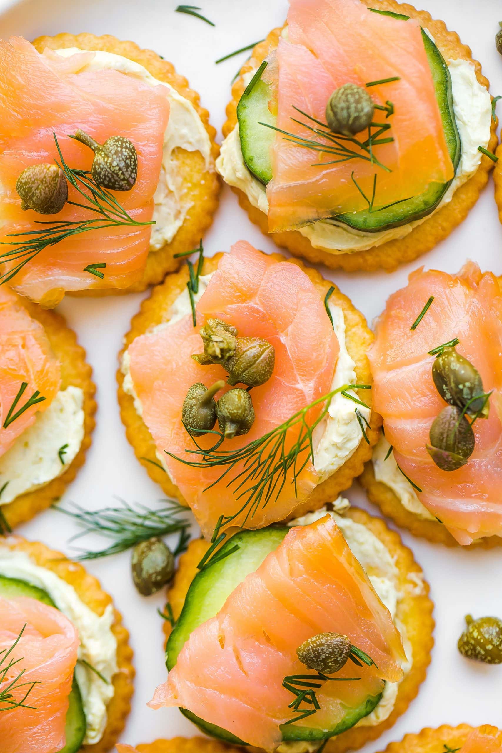 Close up of Smoked Salmon Appetizer Bites with capers and fresh dill on top.