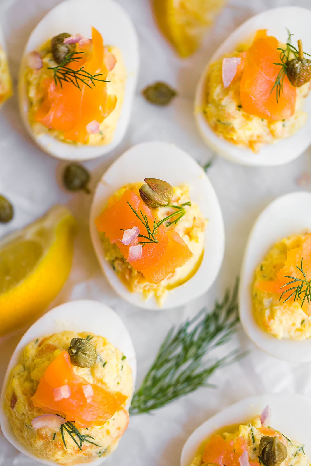 Close up view of deviled eggs with smoked salmon on top.