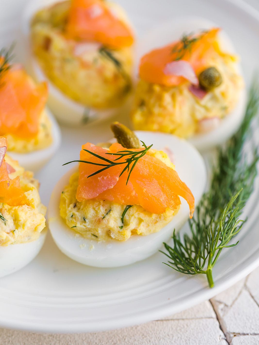 Side view of hard boiled eggs with a sprig of fresh dill.