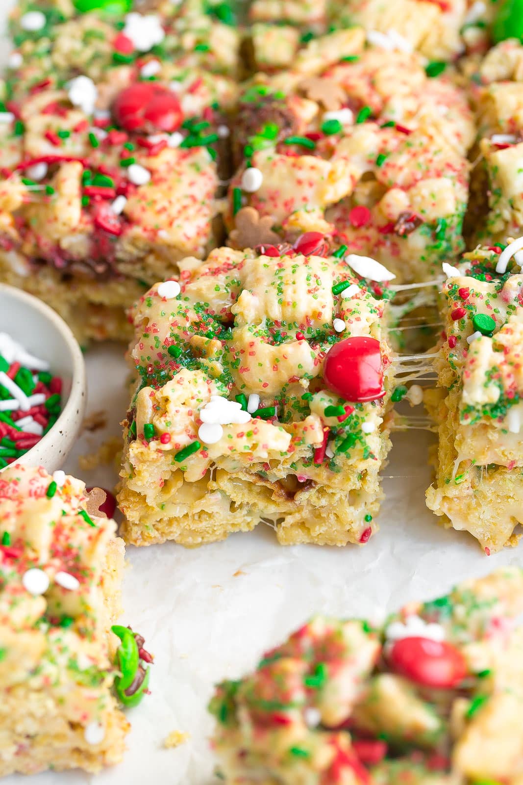 Gooey rice krispie treat with Christmas sprinkles and M&Ms.