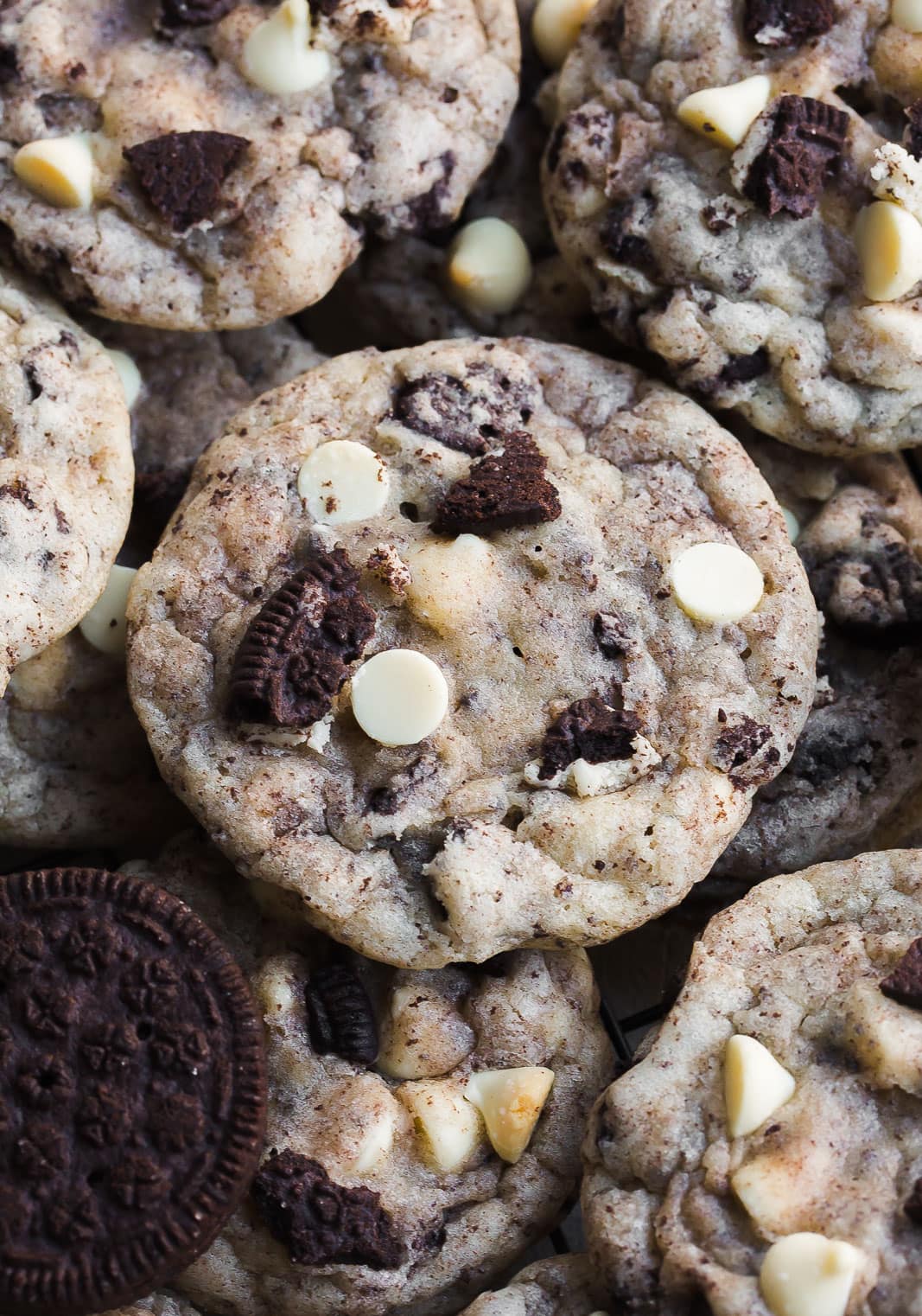 Close up of Oreo cookies with cookie pieces and white chocolate chips.