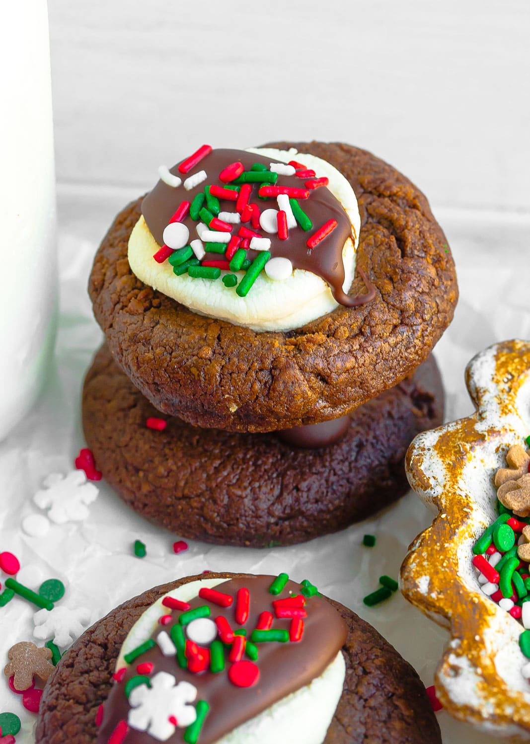 Stack of hot chocolate cookies with marshmallow and sprinkles.