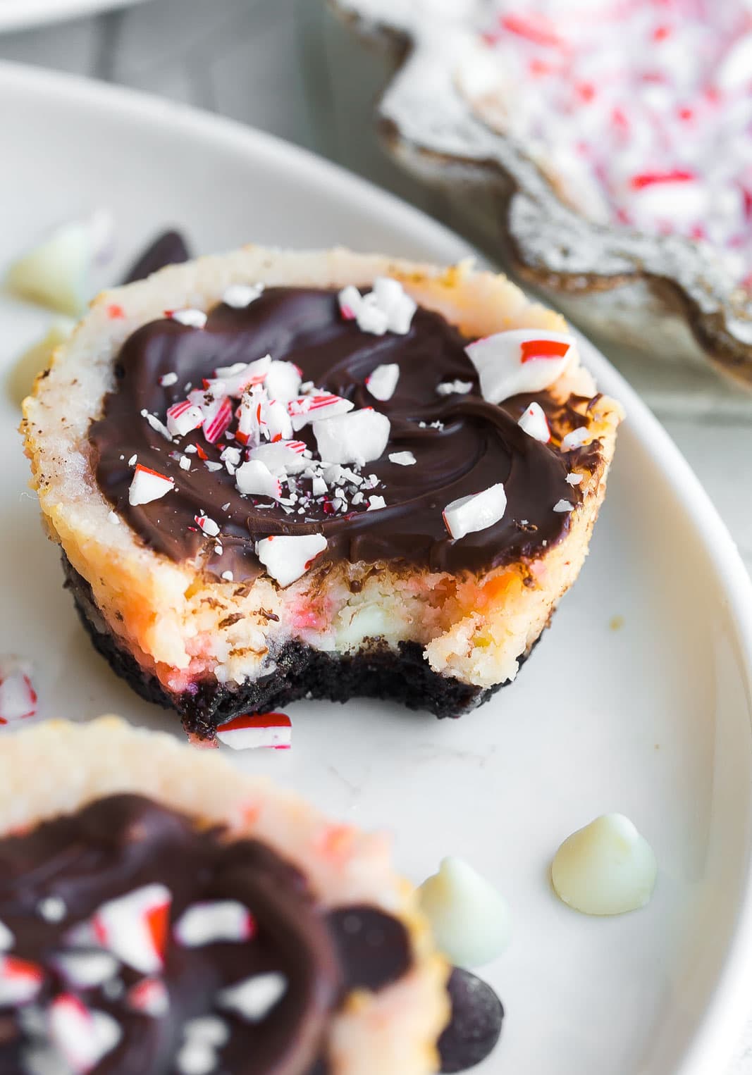 Peppermint Bark Cheesecake Bites with a bite mark. 
