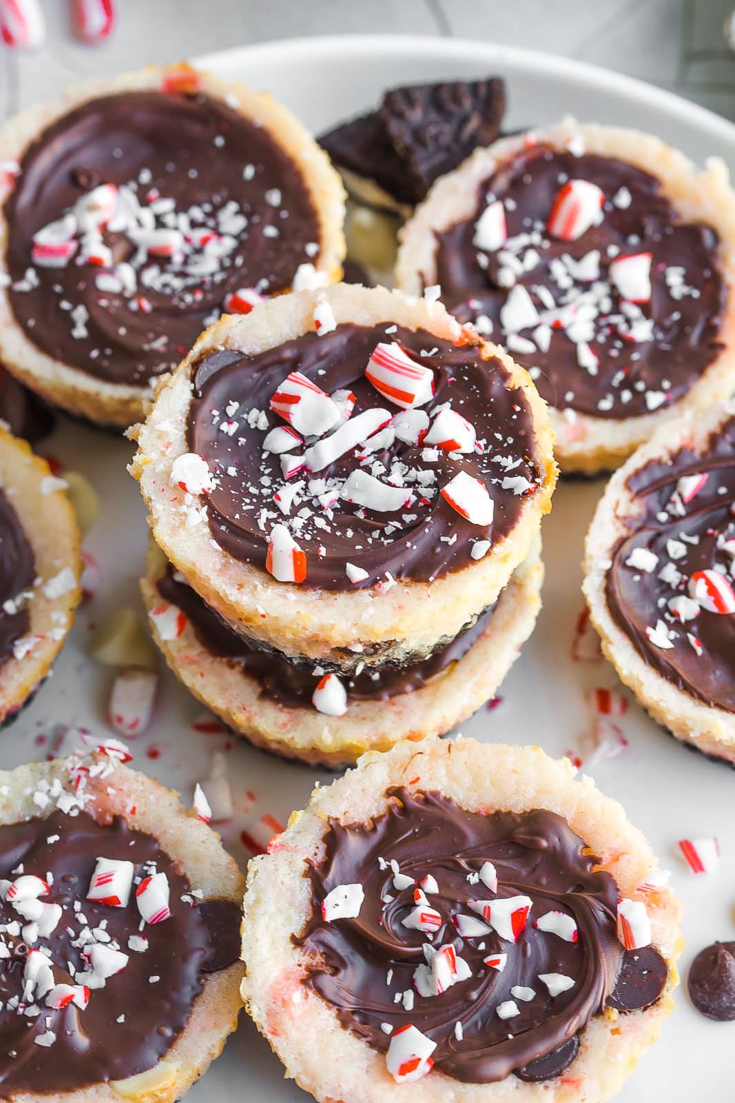 Peppermint Bark Cheesecake Bites stacked on sweet. 