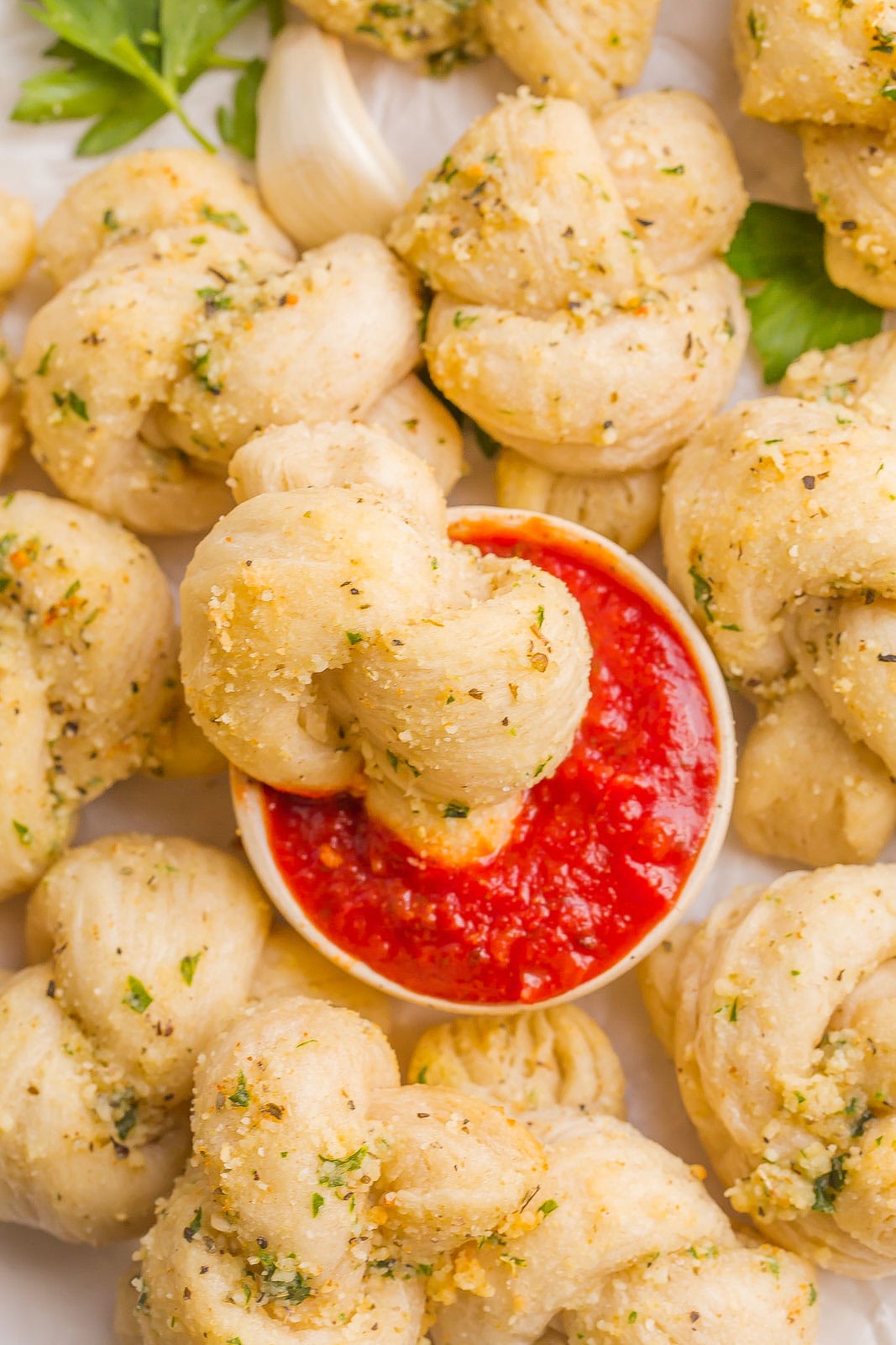Garlic knot dipped in pizza sauce.