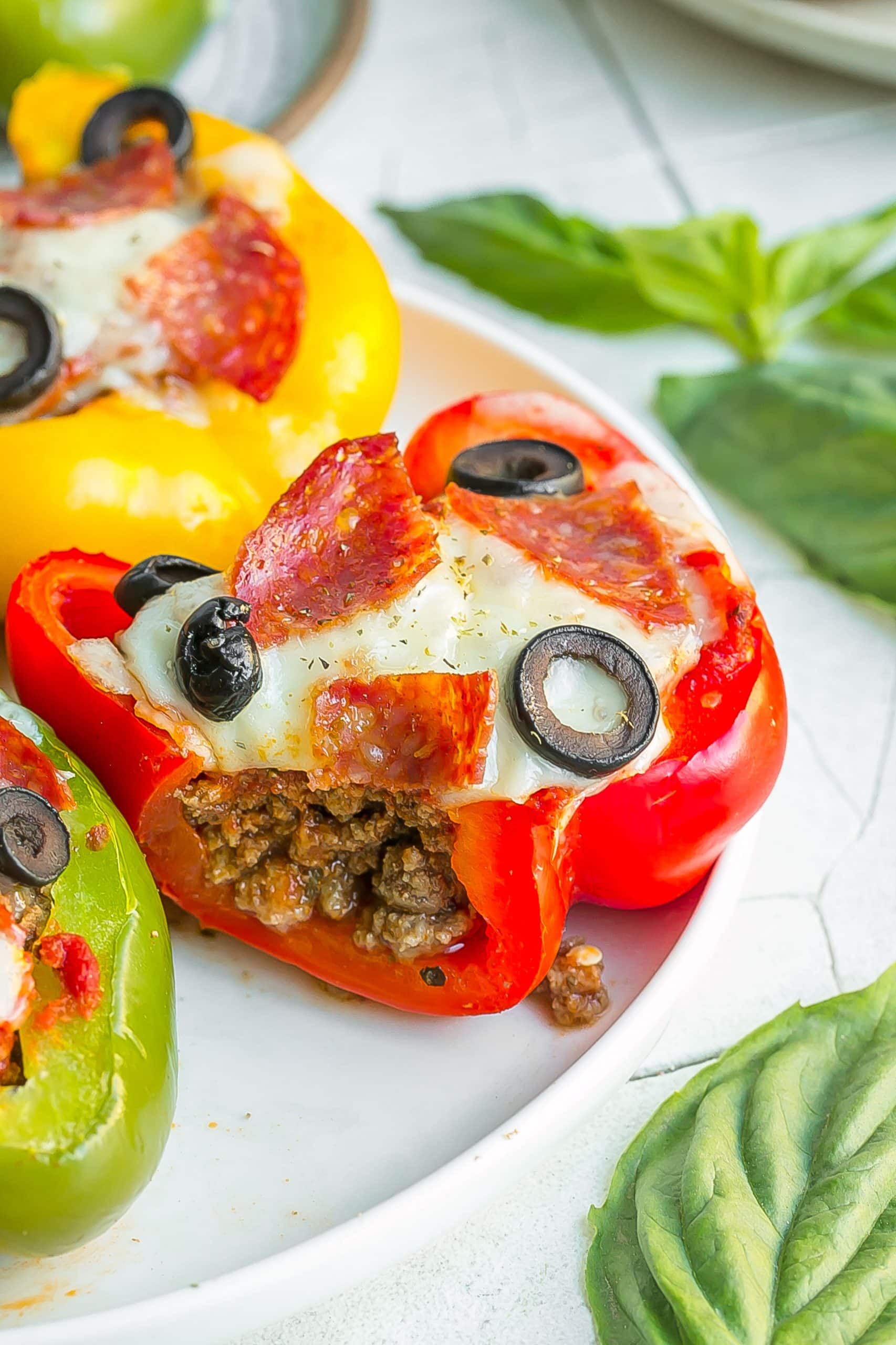 Opened Pizza Stuffed Pepper on a white plate.