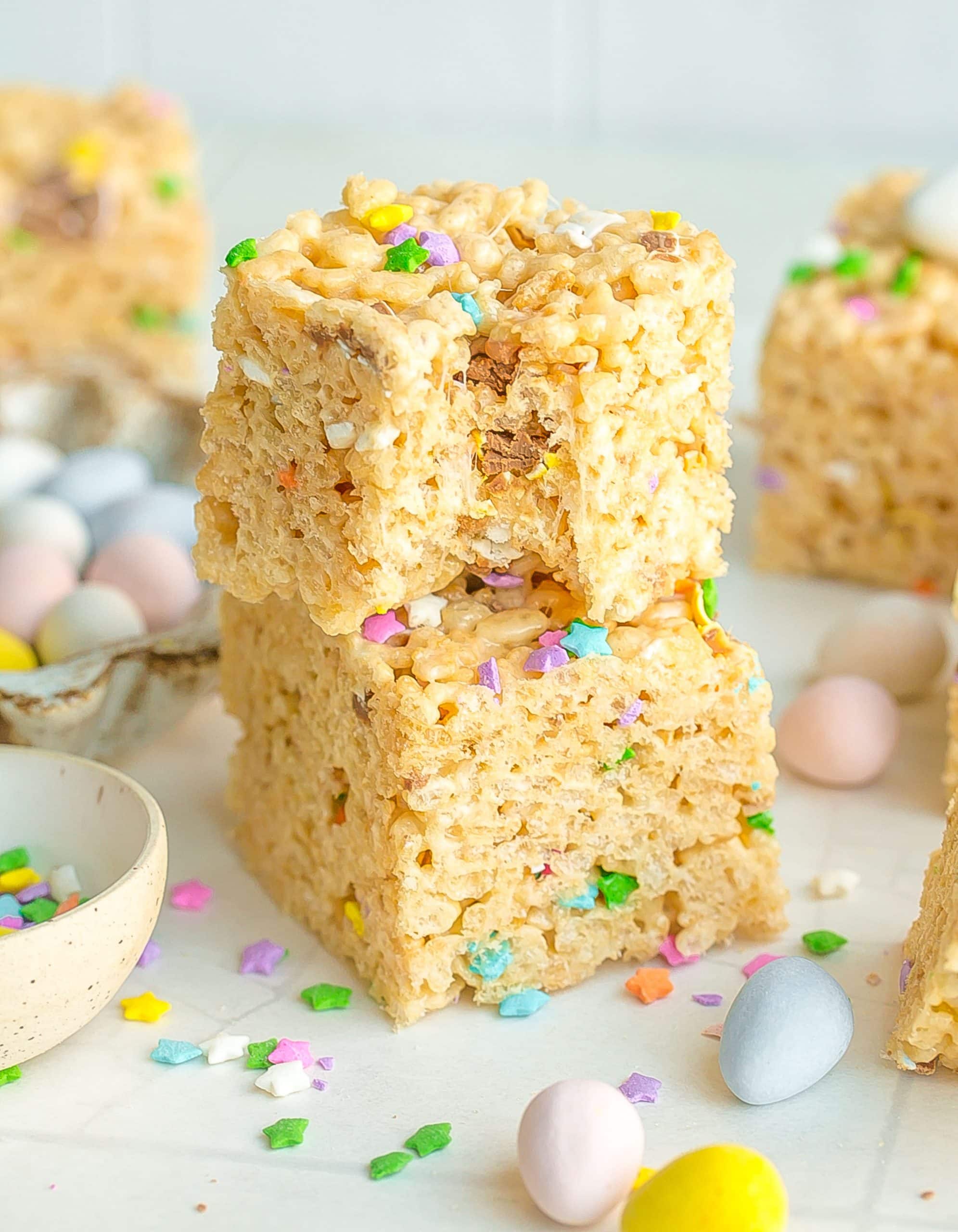 Stack of Easter Rice Krispie Treats with bite mark in middle. 