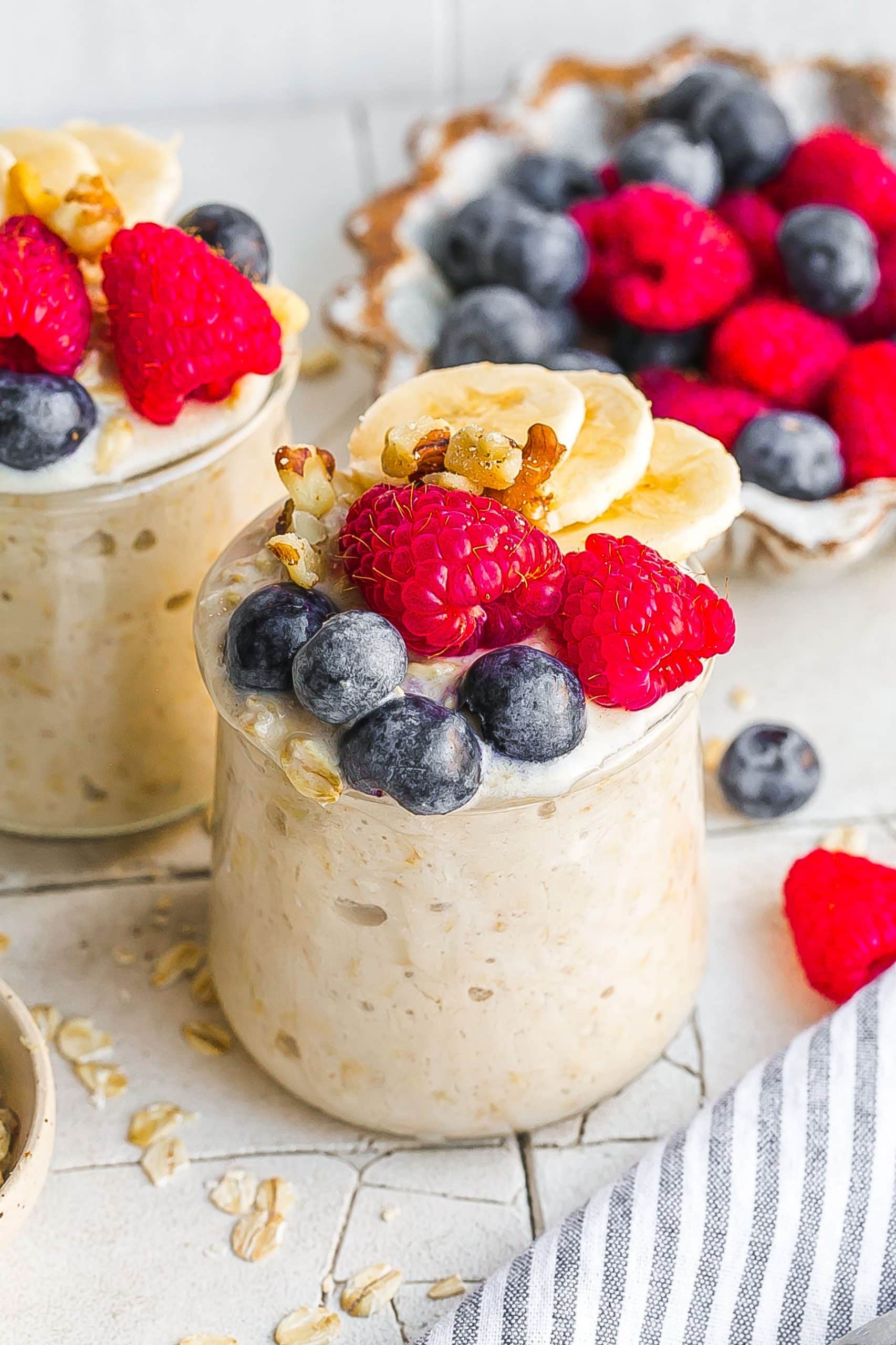 Overnight Oats With Almond Milk and berries in a small jar.