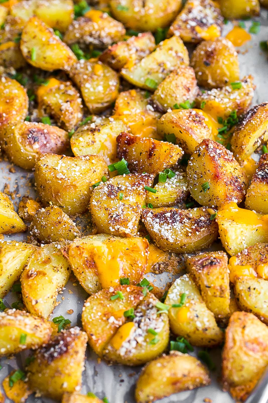 Cheesy Roasted Parmesan Potatoes garnished with chives. 