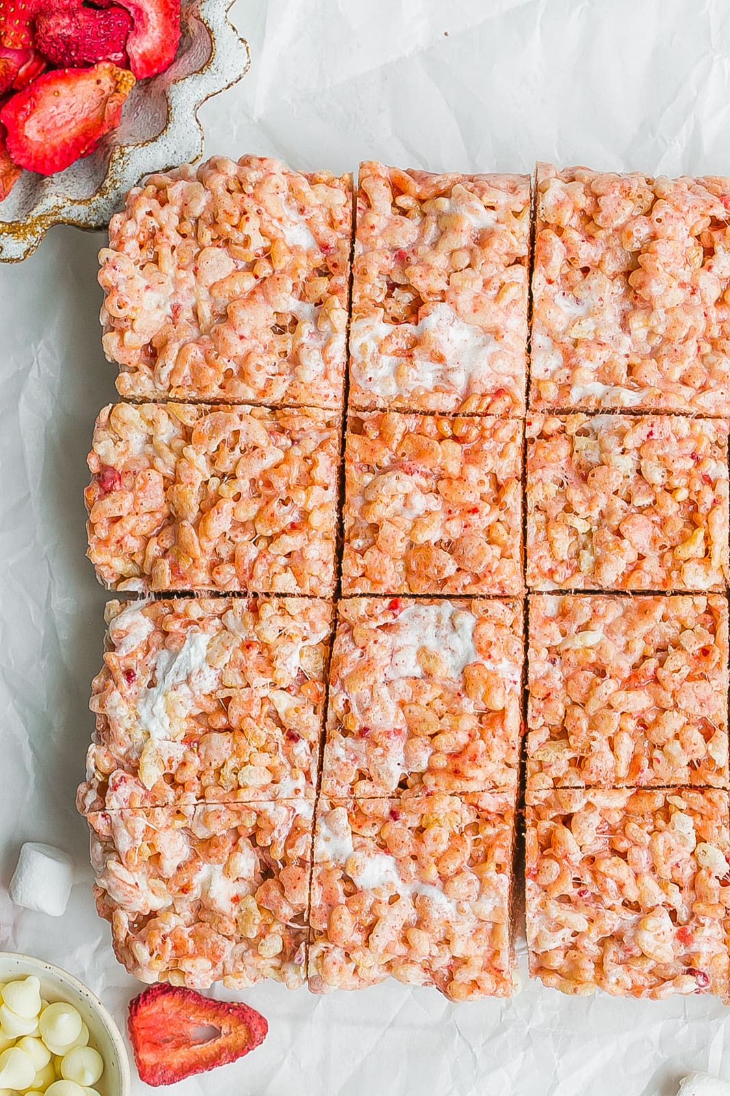 Cut up rice krispie treats with strawberries. 