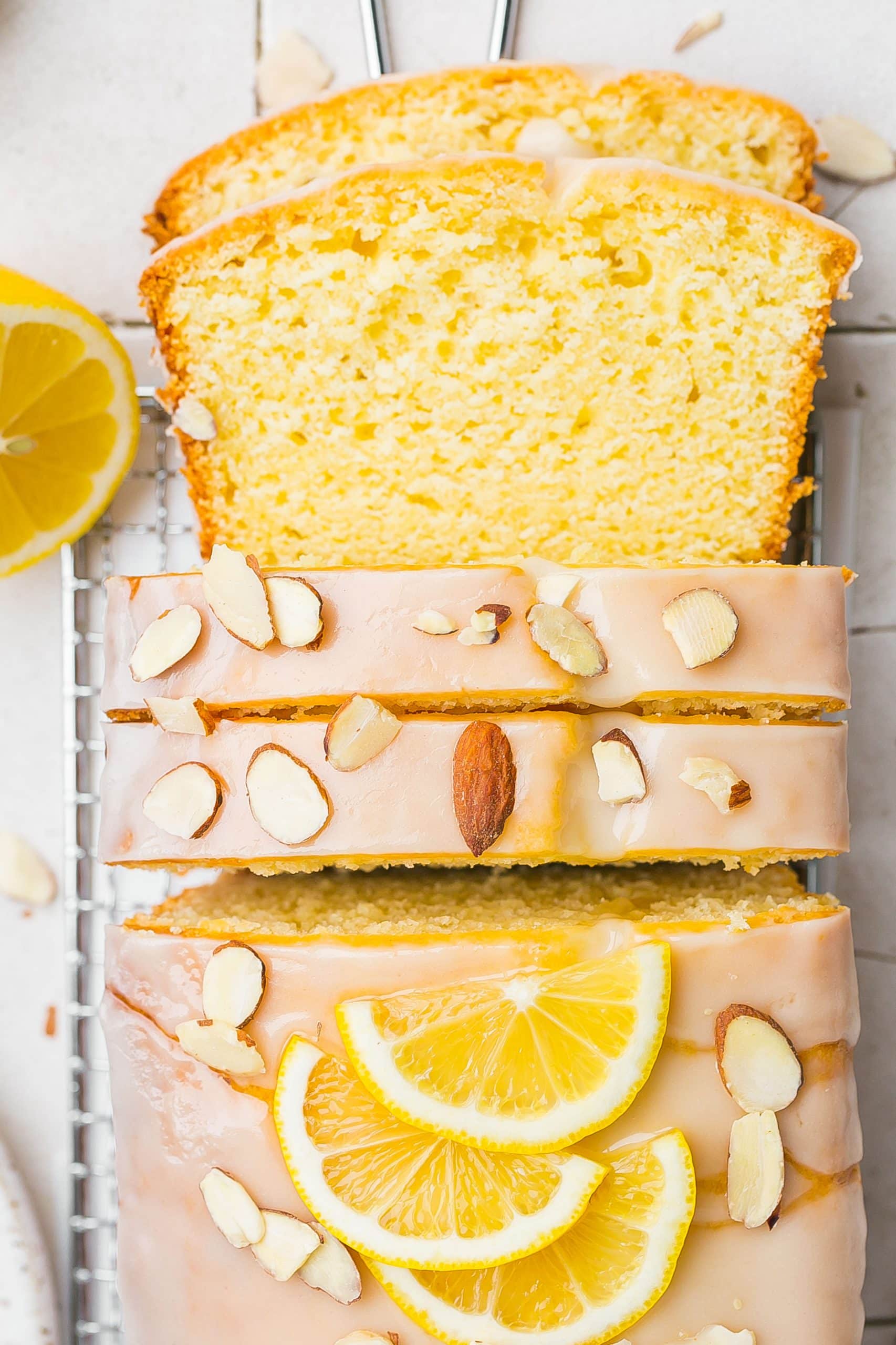 Iced loaf cake with icing and almonds.