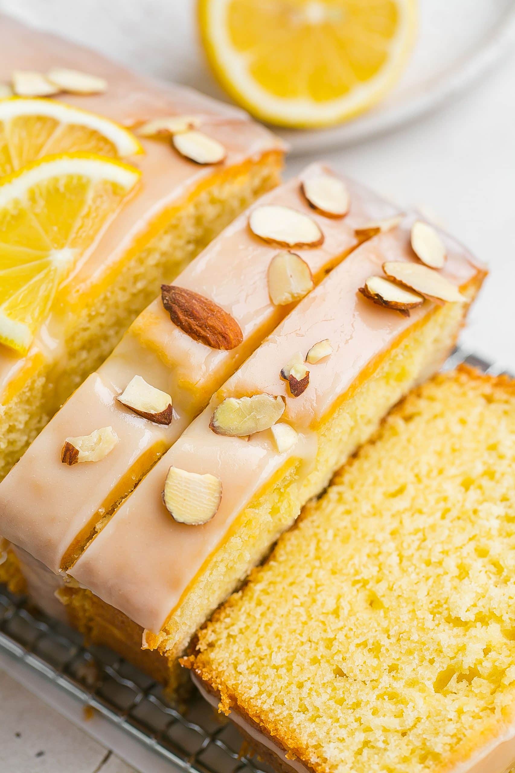 Side view of sliced cake with almonds on top.