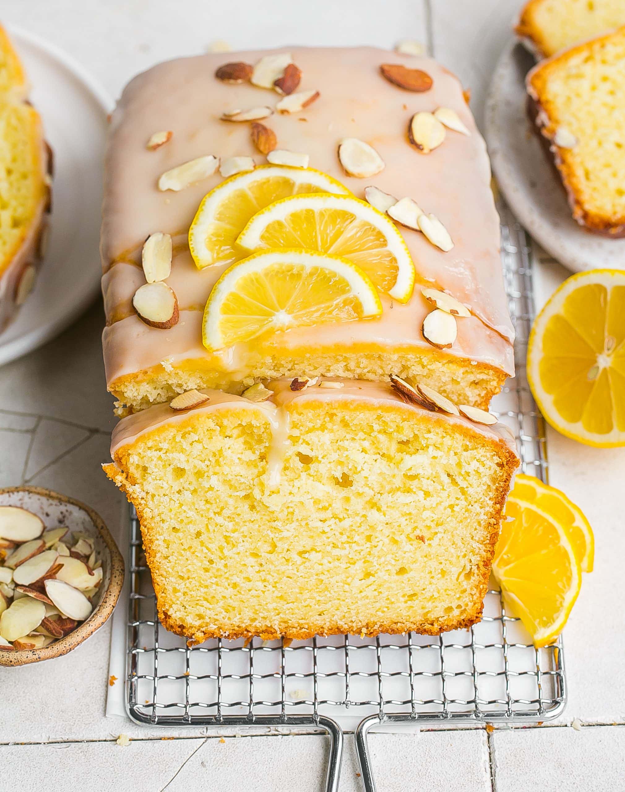 Loaf cake with sliced almonds and lemons.