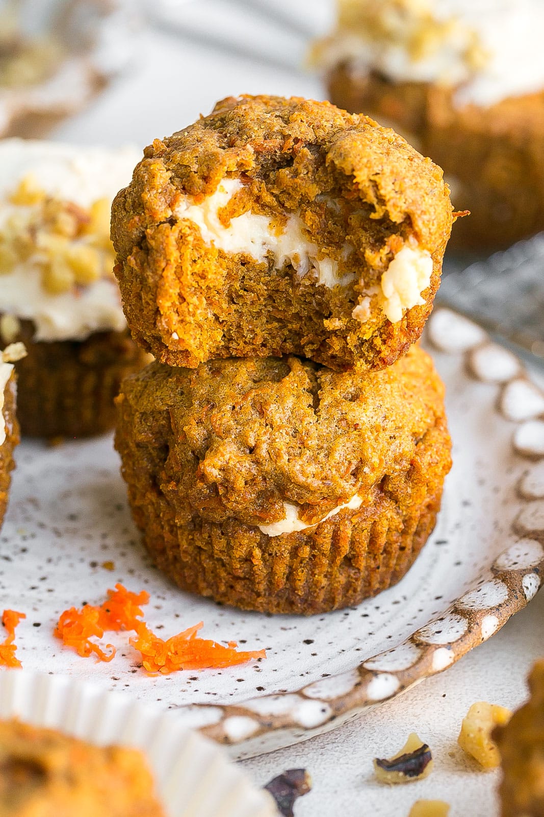 Cream Cheese Filled Carrot Cake Muffins stacked on top of each-other.