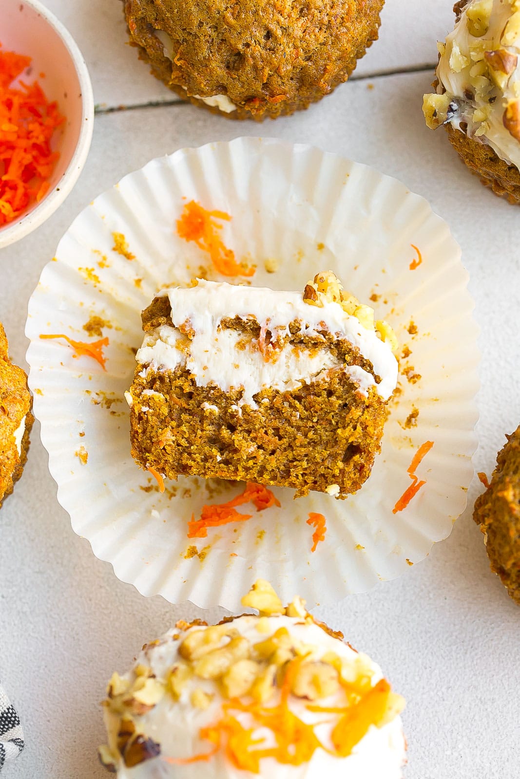 Inside of a carrot cake muffin with cream cheese filling.