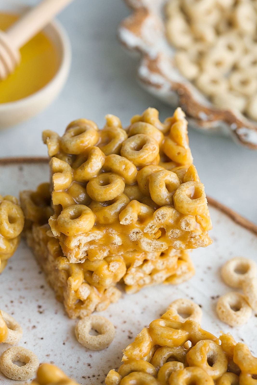 Peanut Butter Cheerio Bars stacked on plate.