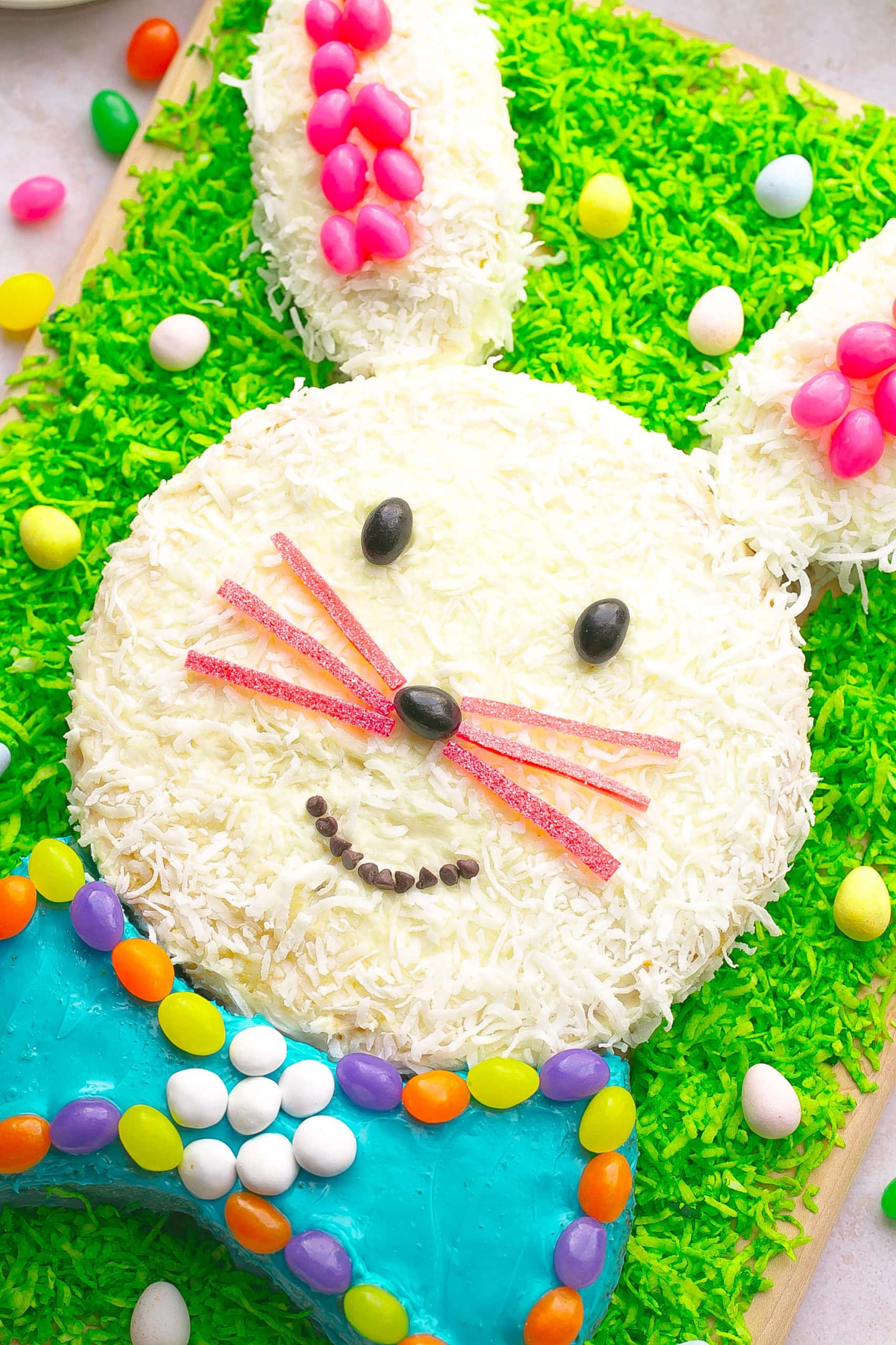 Coconut Easter Bunny Cake with coconut grass and candies.
