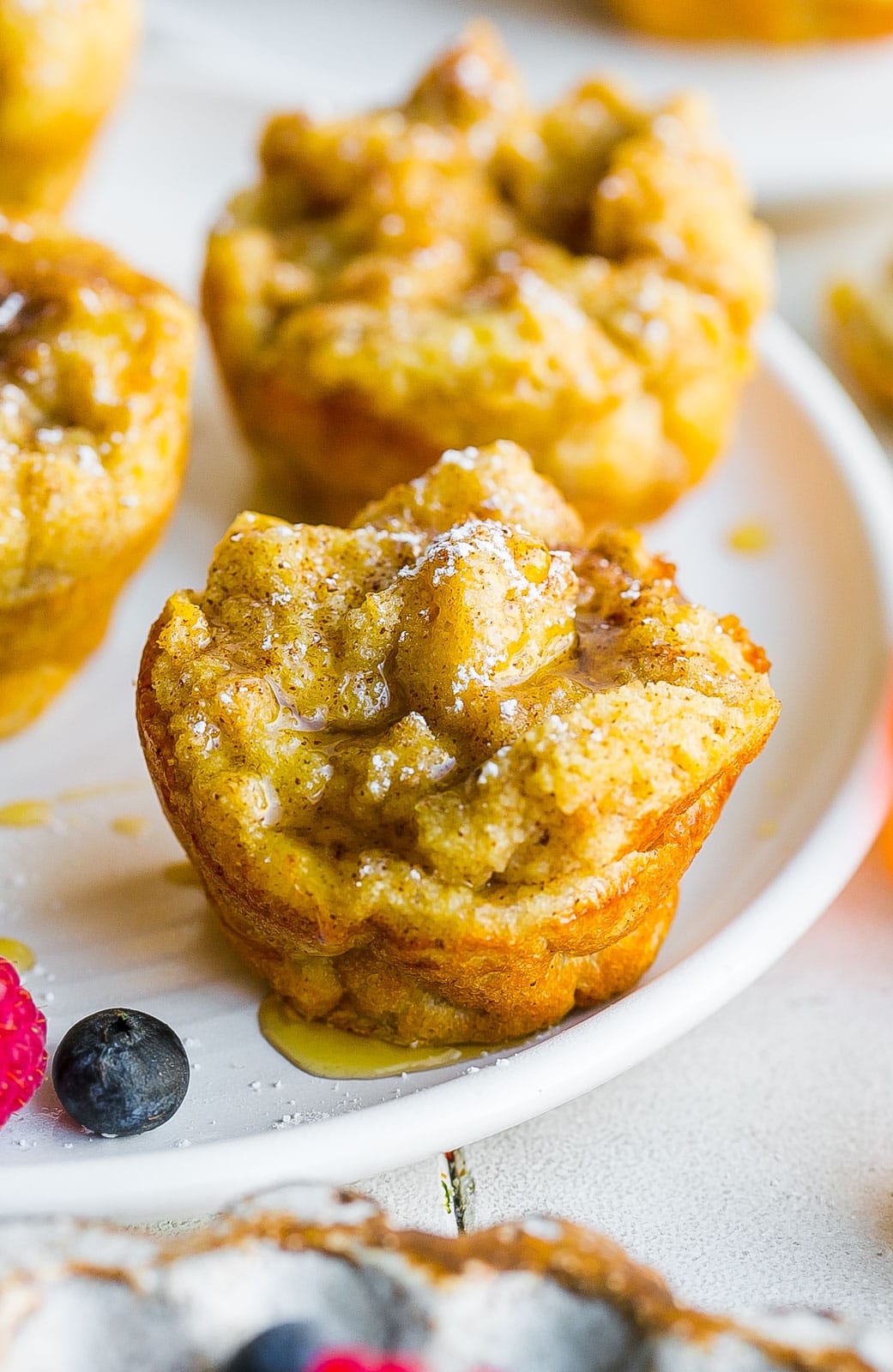 French toast on a plate in a muffin form with syrup. 