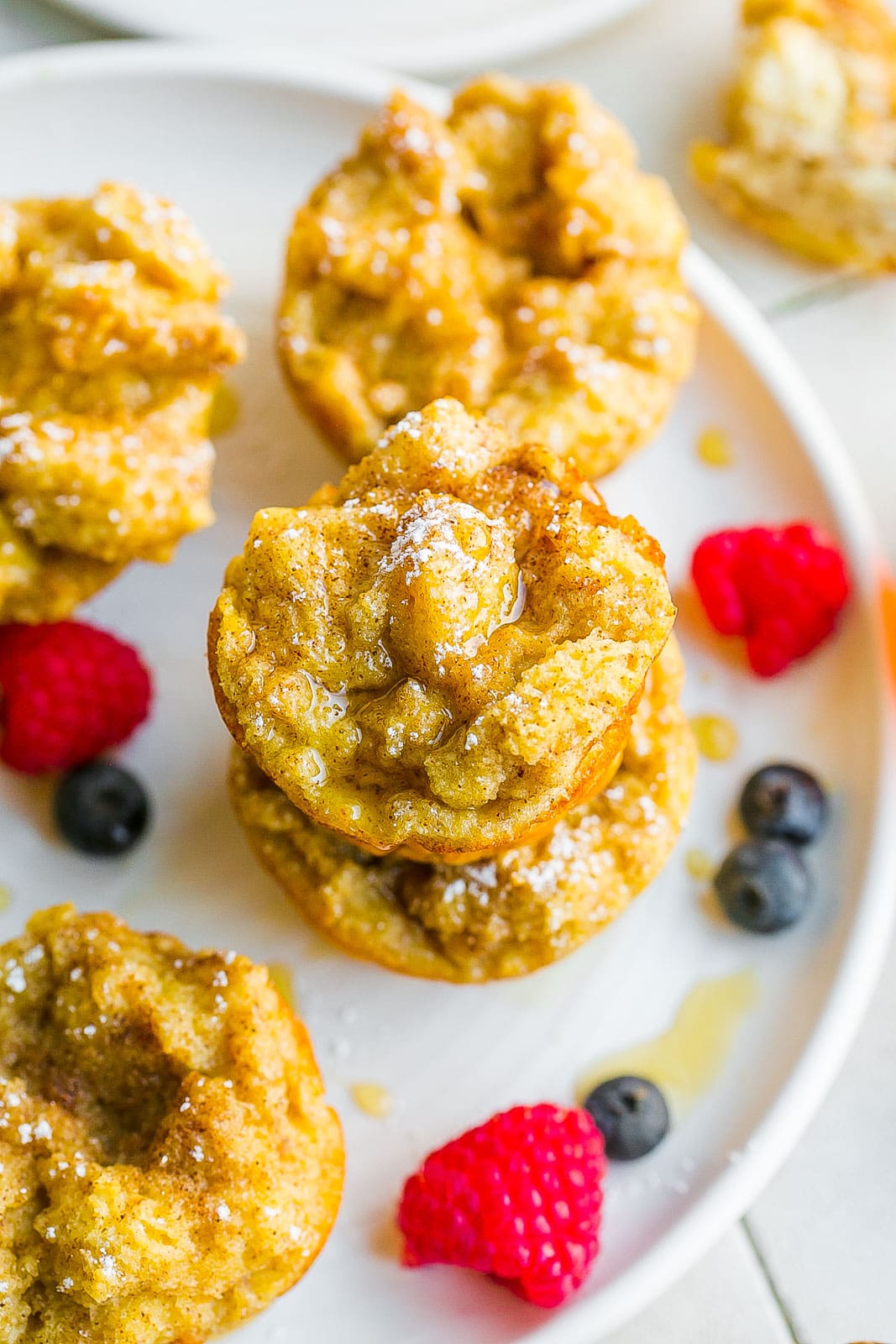 French toast muffins stacked together on a plate.