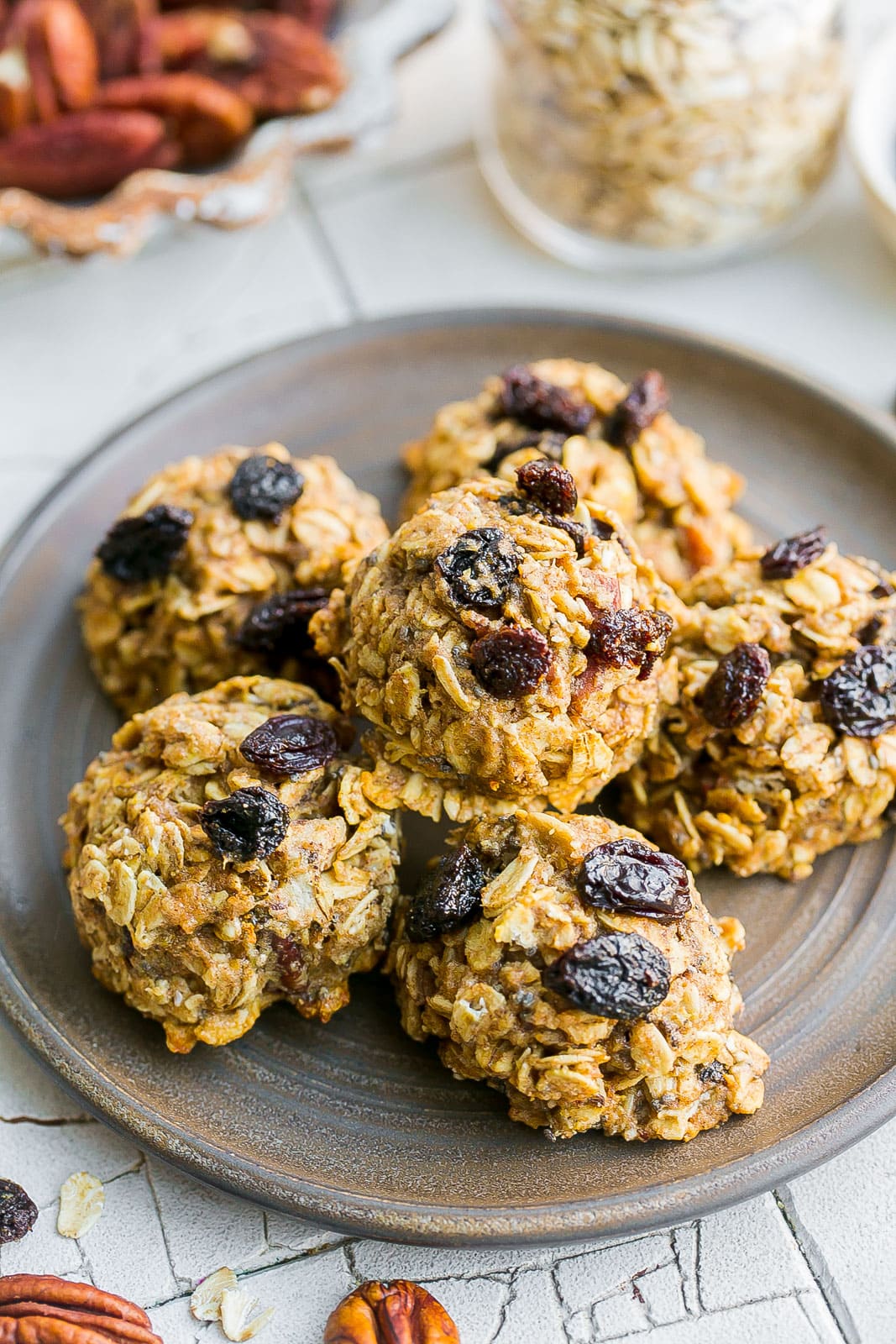 Oatmeal cookie with raisins on plate.