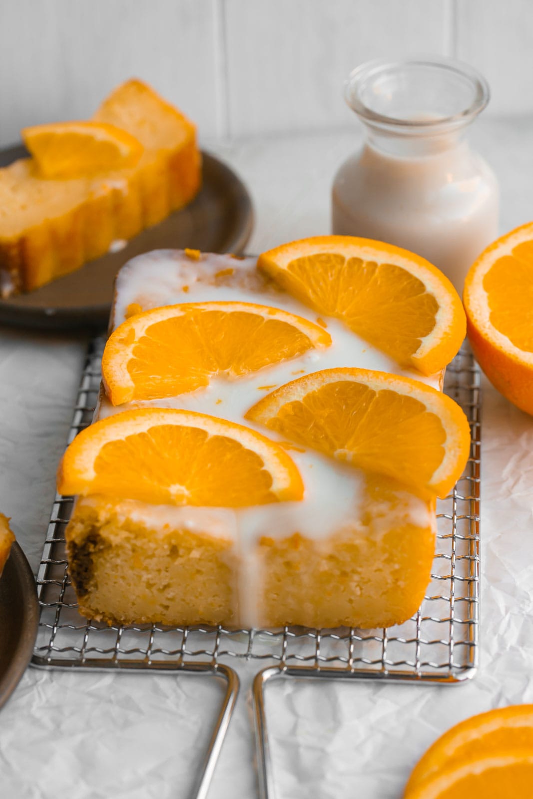 Orange loaf cake with icing dripping down.