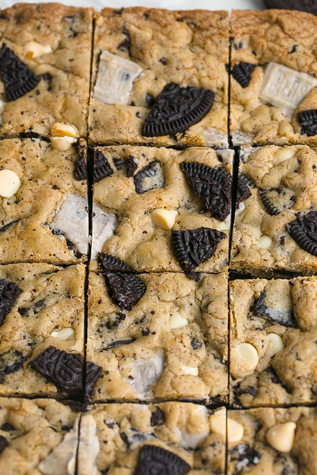 Cookies and cream Oreo blondies cut into squares in baking pan.