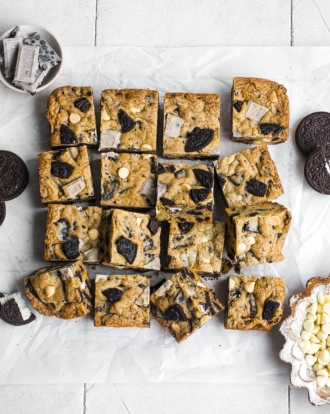 Oreo bars cut into squares on parchment paper.