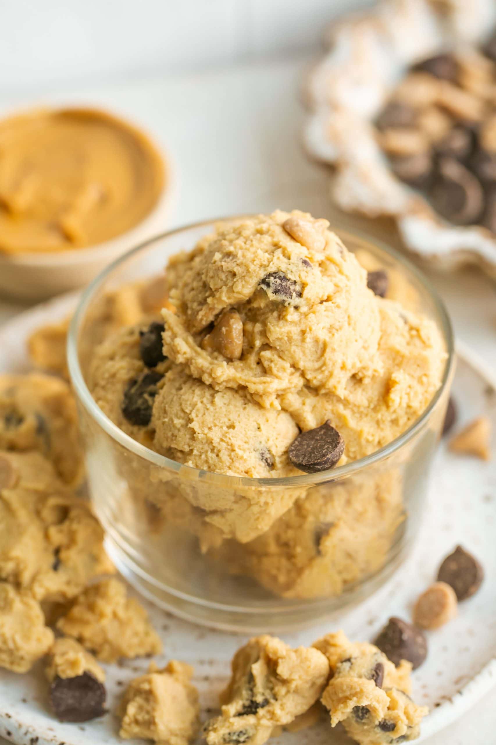 Scoops of peanut butter cookie dough in glass cup.