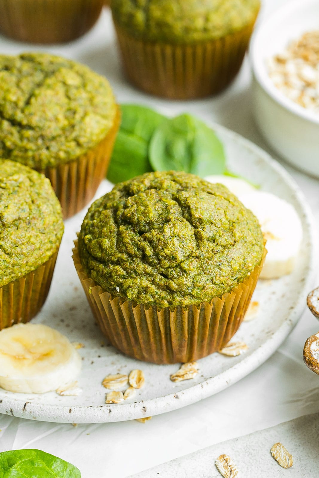 Close of of green muffin on plate. 