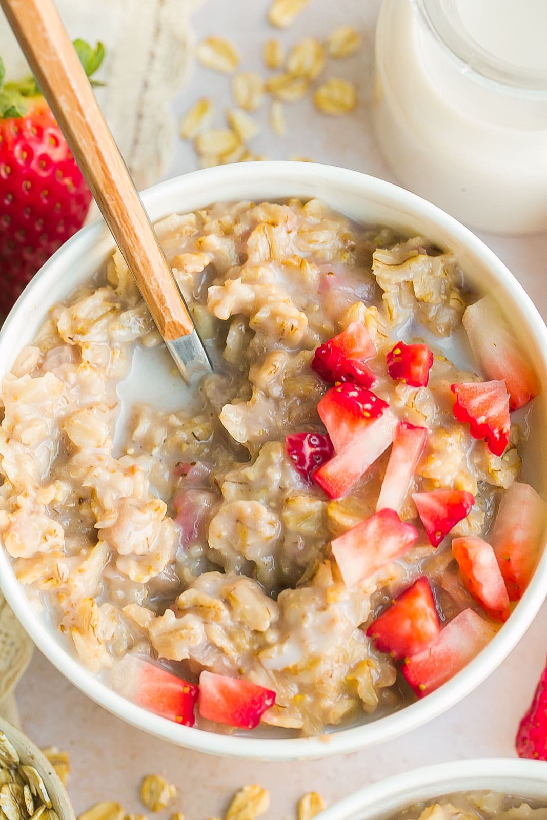 Strawberries and cream oatmeal in a white bowl. 