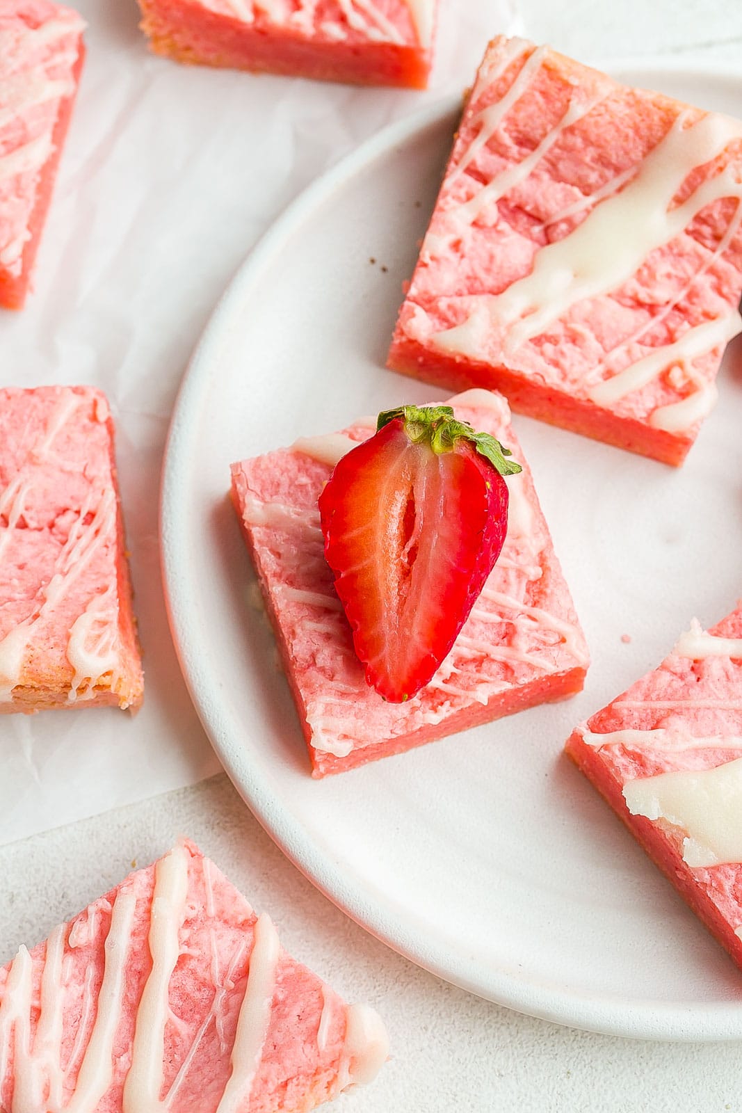 Strawberry brownies recipe with fresh strawberry on top.