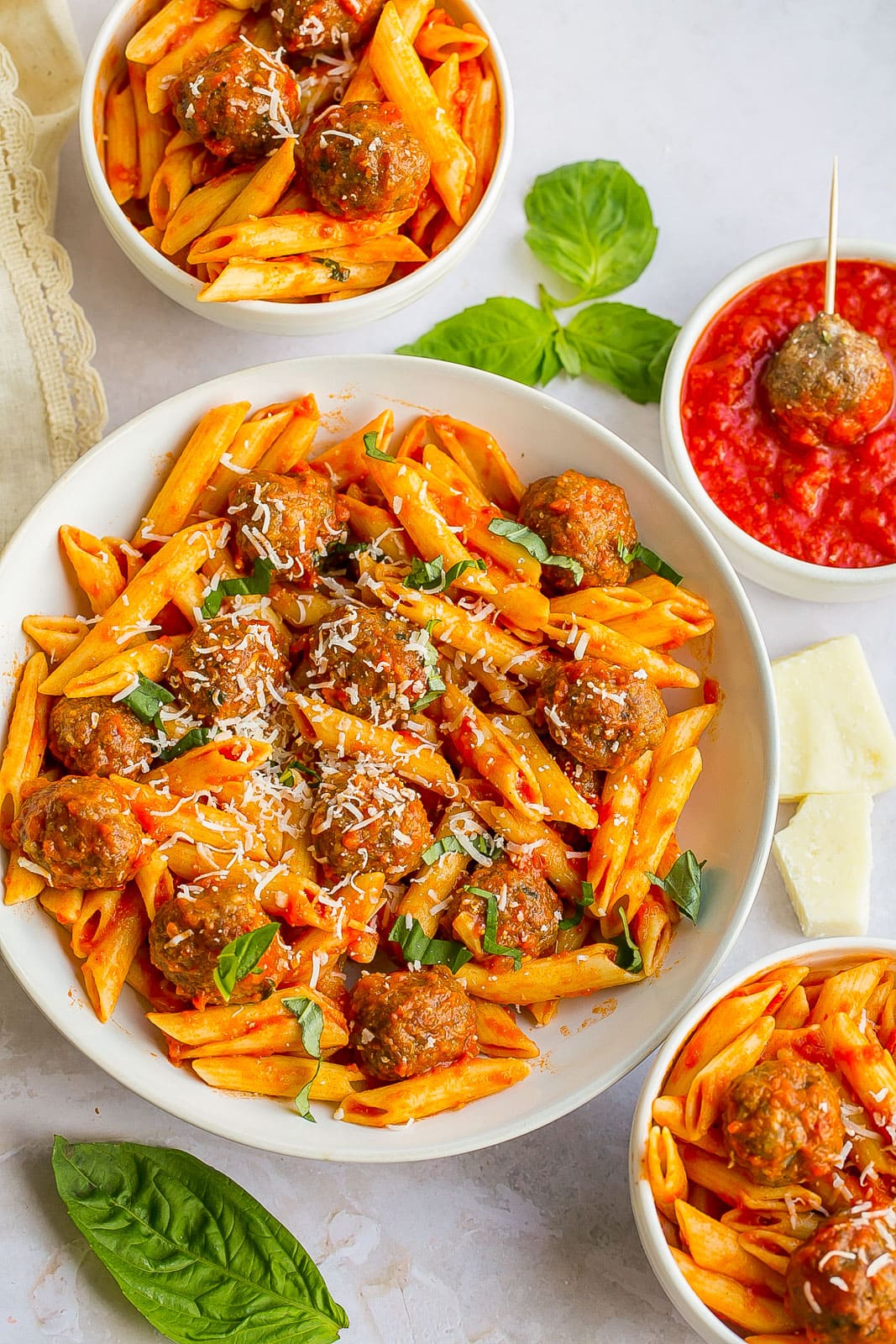 Large bowl of pasta and mini meatballs.