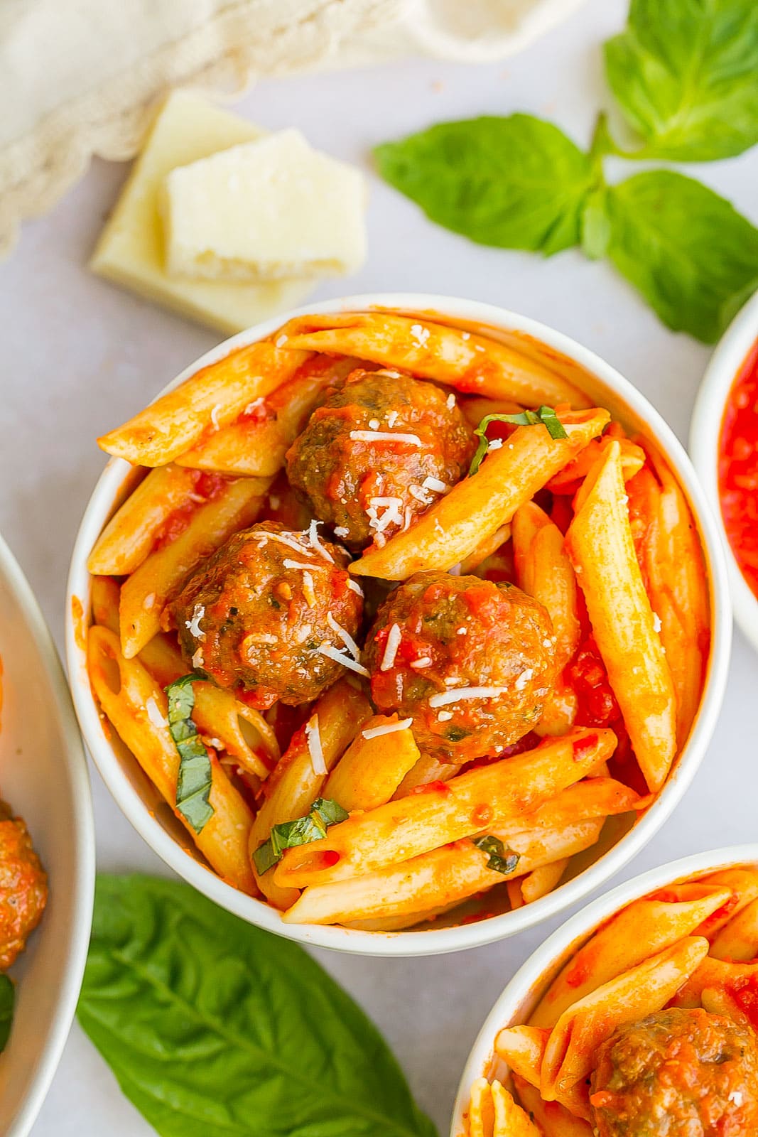 Pasta with mini meatballs in a bowl.