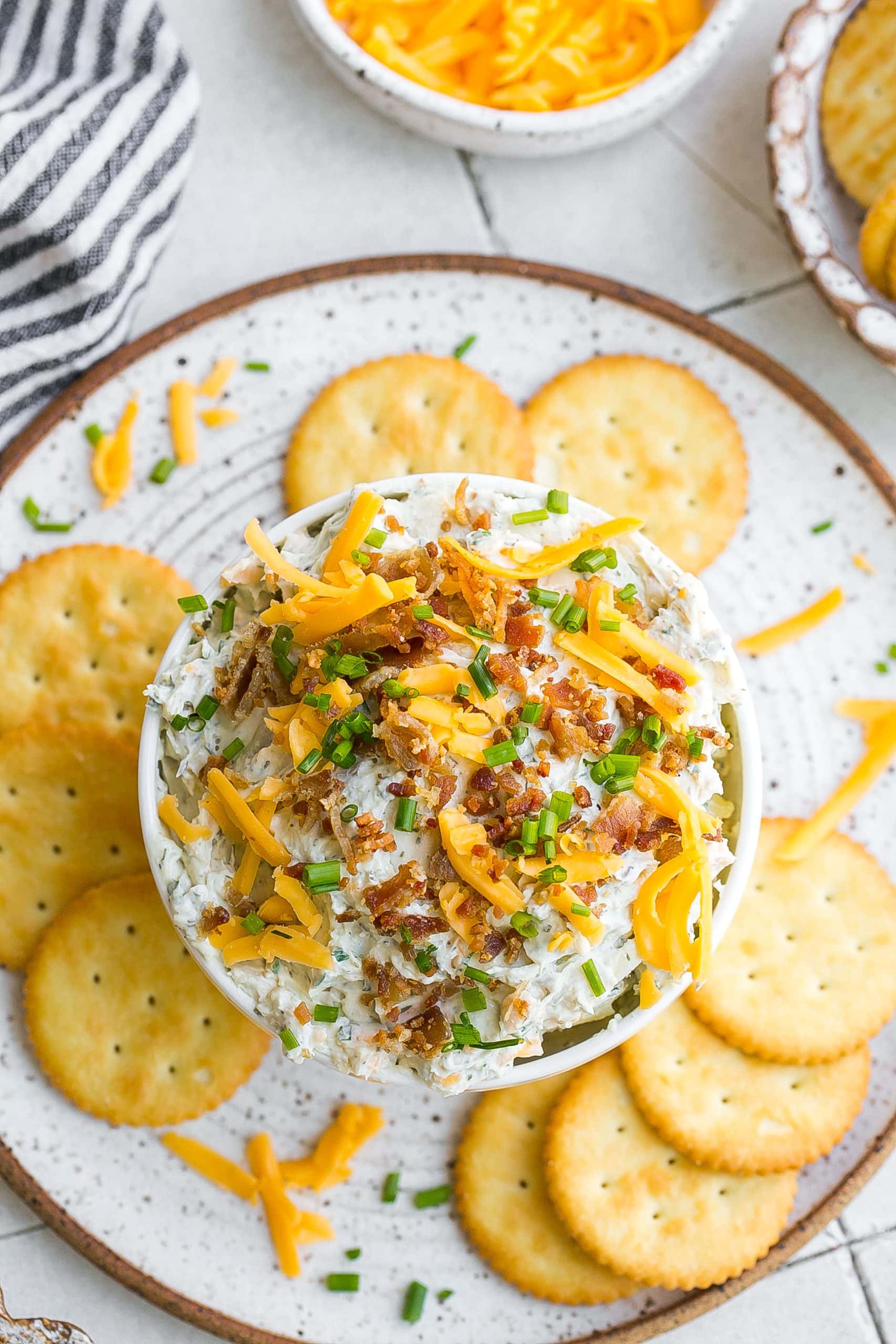 Birds eye view of bacon dip with cheddar cheese, ranch and chives. 