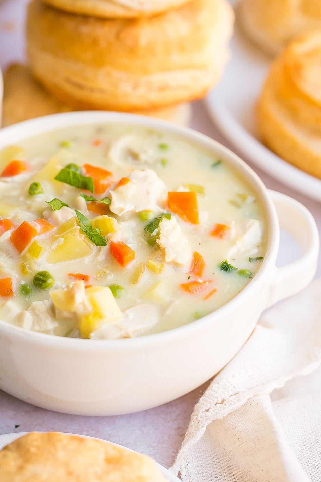 Side view of a bowl of chicken pot pie soup.