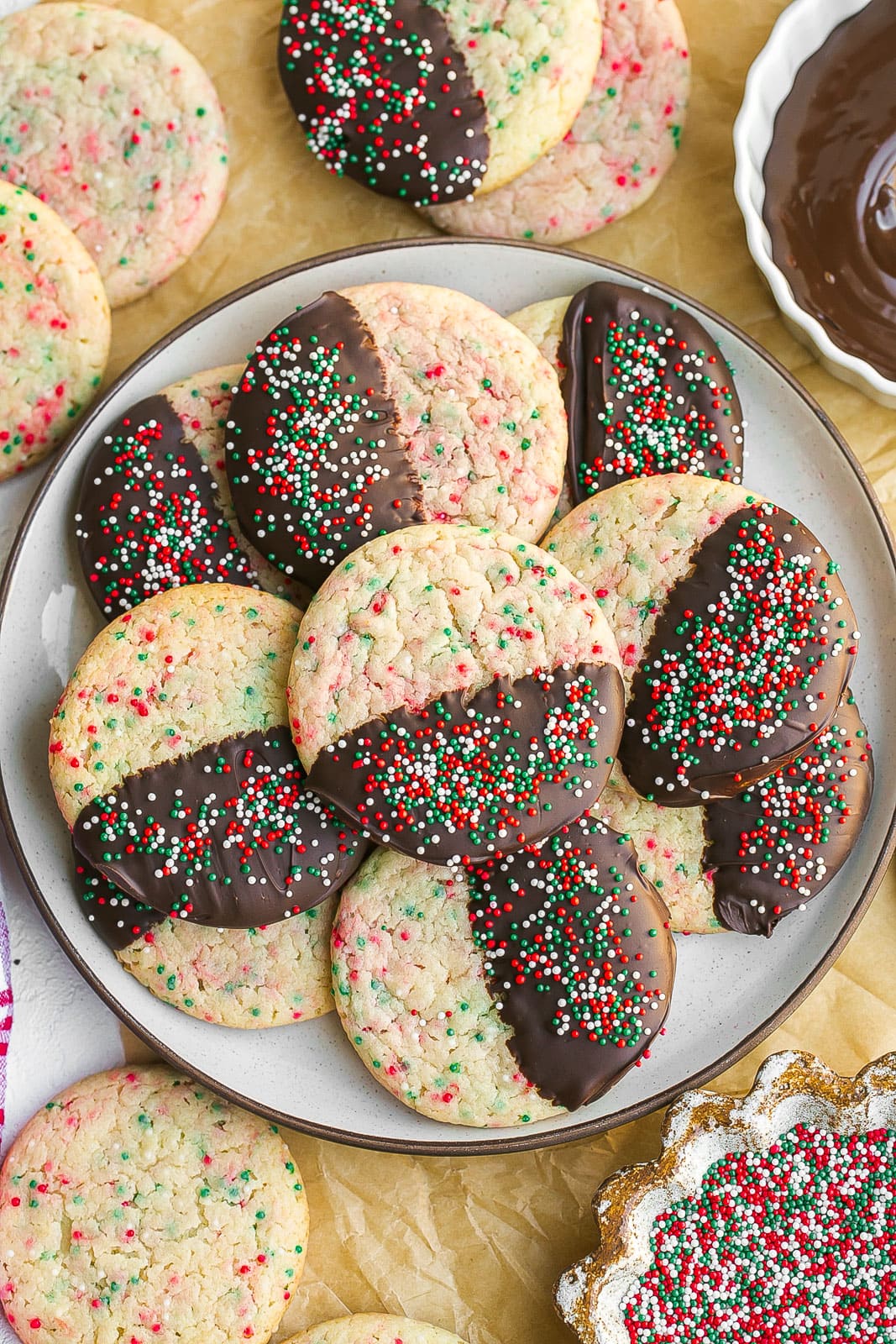 Plate of chocolate dipped cookies with sprinkles.