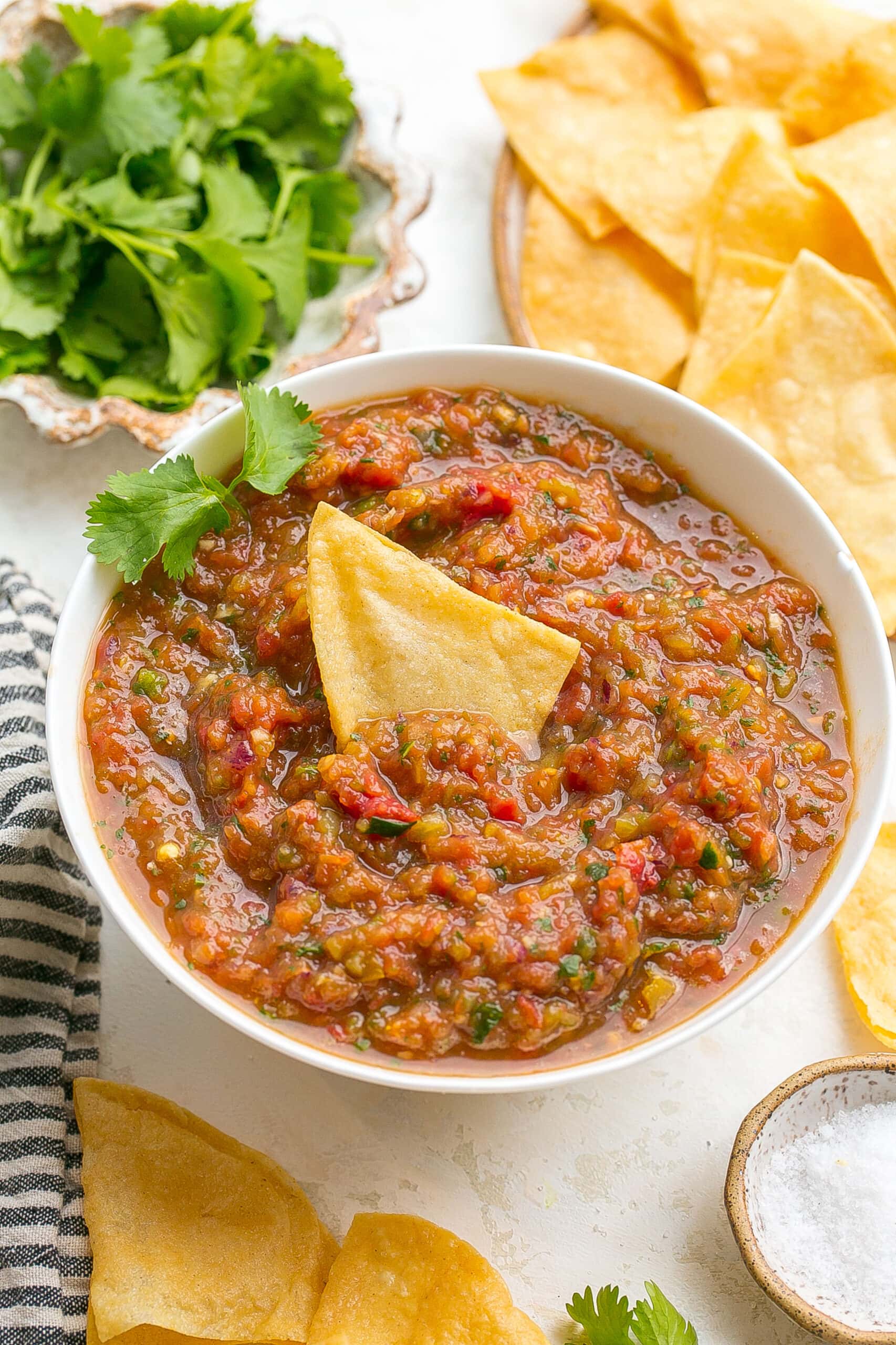 Blender salsa in a bowl with a chip.