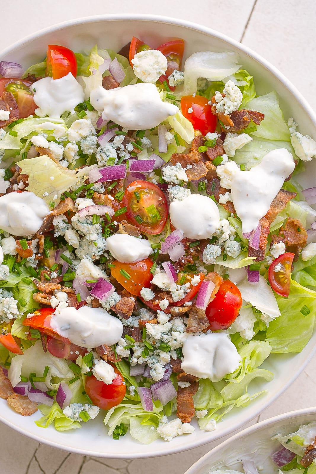 Chopped Wedge salad with dressing on top.