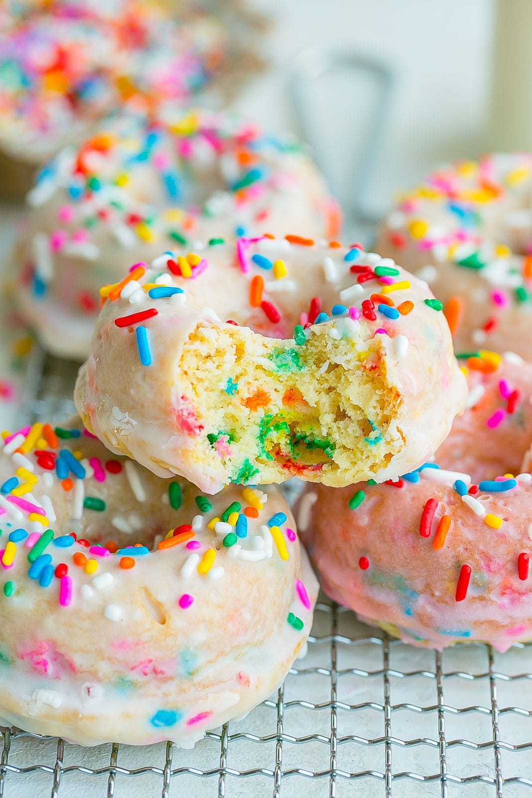 Bite of a sprinkle baked donut.