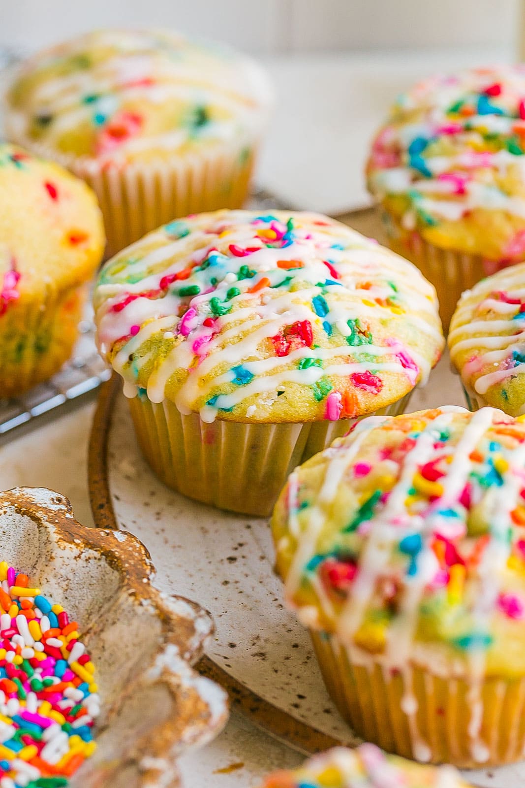 Side view of muffin with rainbow sprinkles.