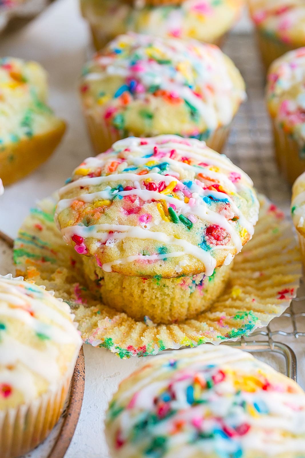 Glazed muffins with rainbow sprinkles.